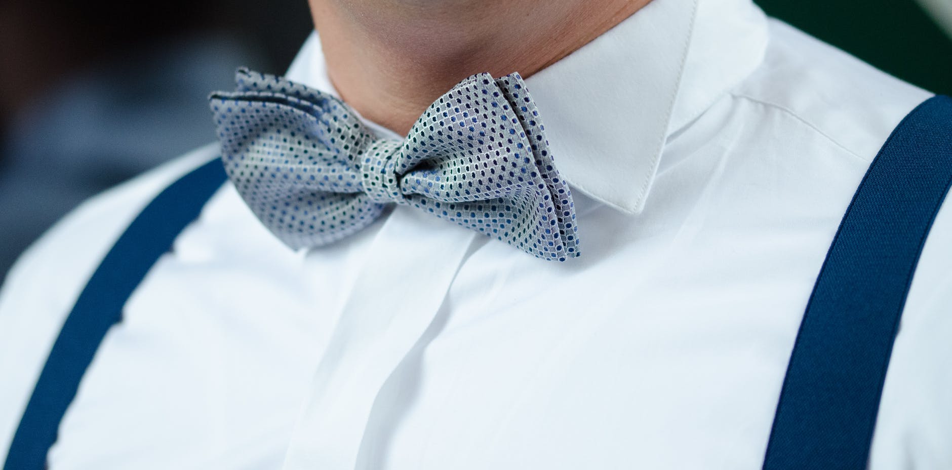 man in white dress shirt blue suspenders and gray polka dotted bowtie Photo by Pixabay on Pexels.com